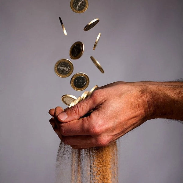 Hand catching falling coins with sand slipping through fingers, product image for the Ditch the Leeches wealth protection spell by Slavic Witch