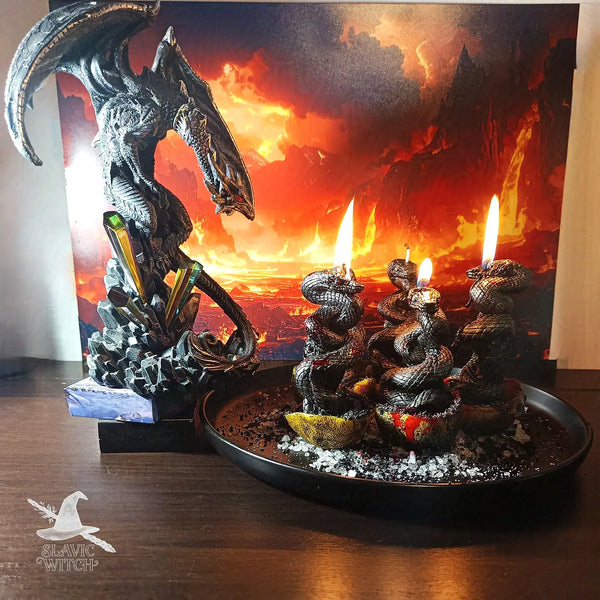 Black dragon statue with dark serpent candles on a plate, used in the Wrath of the Dragon multi-person curse ritual by Slavic Witch